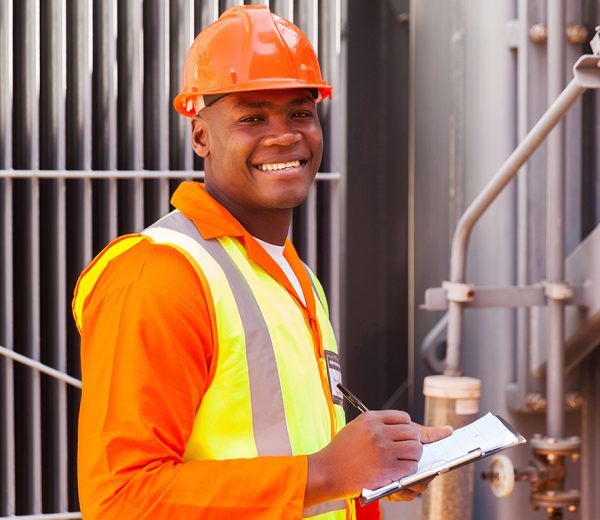 male african electrical worker in front of transformer